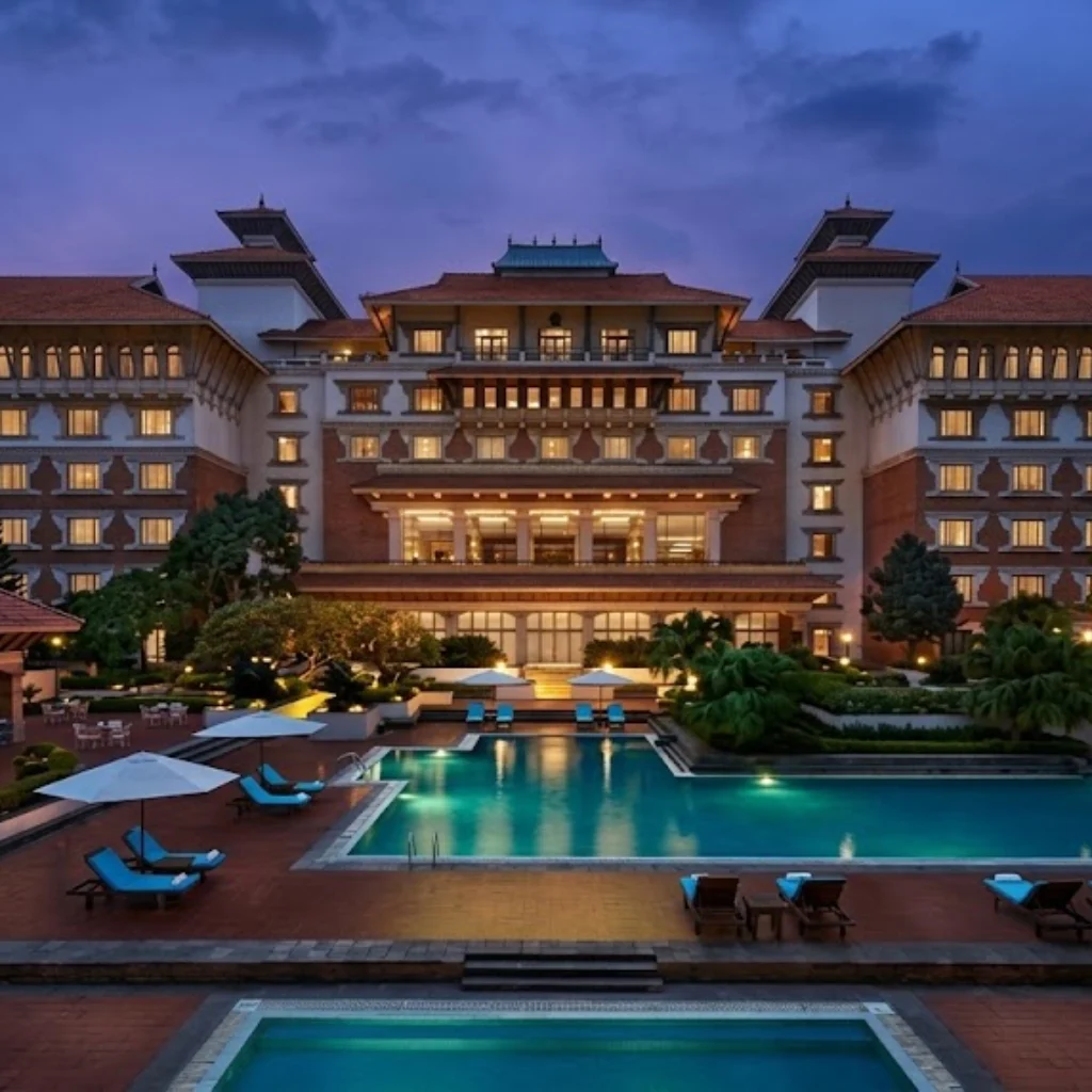 Heritage luxury hotel courtyard and illuminated swimming pool at twilight with traditional Newari roofs.