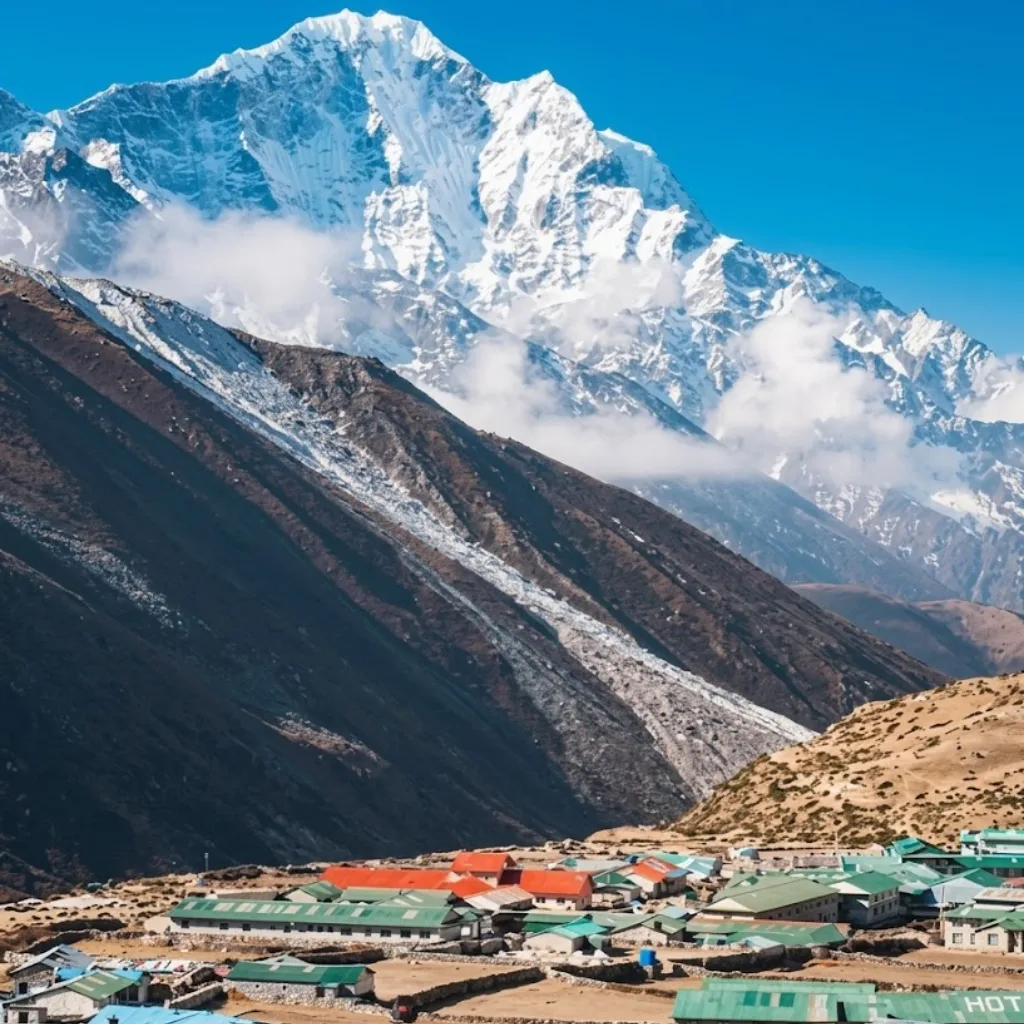 Stone lodges of Dingboche village nestled below clouds and the snow-covered south face of Lhotse.